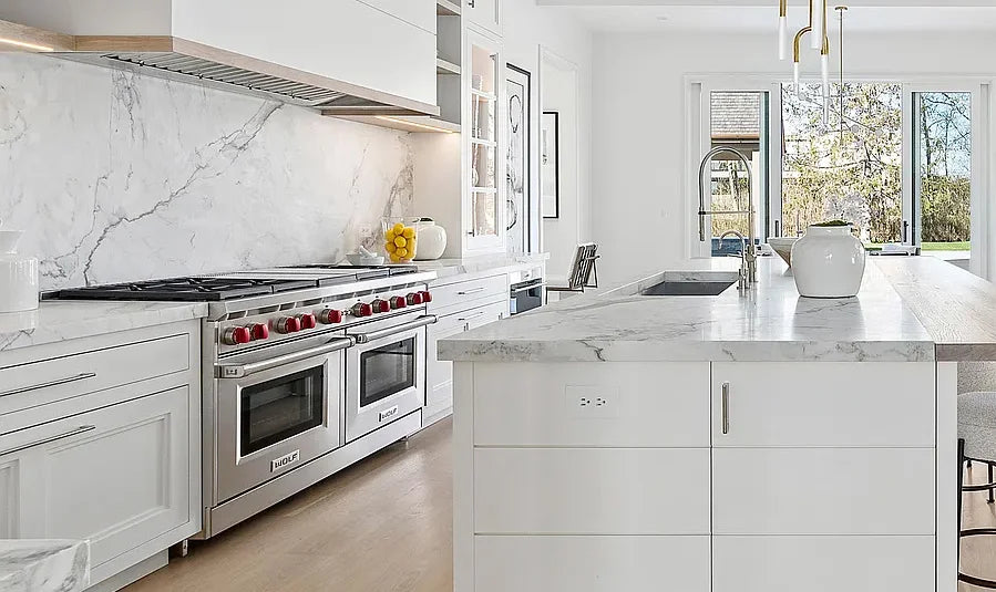 Custom kitchen island with a flush mounted outlet hidden in the cabinetry panel